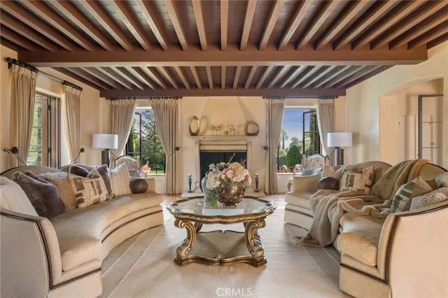 a living room with furniture a fireplace and a table