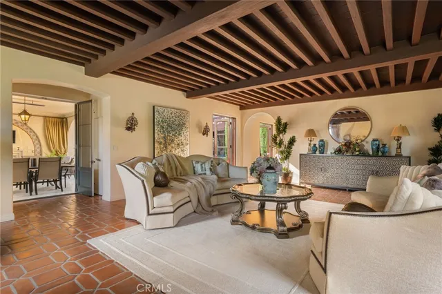 a living room with furniture a fireplace and a chandelier