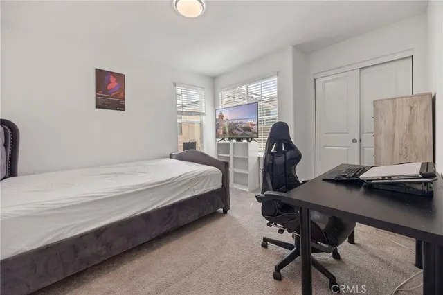 a bedroom with a bed and a desk