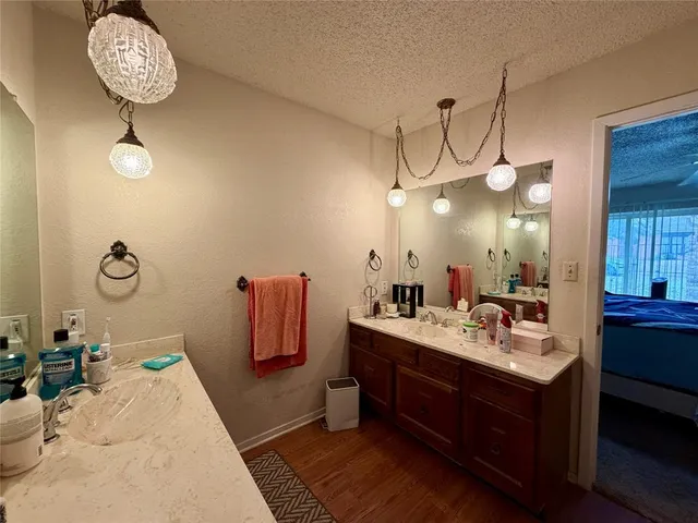 a bathroom with a sink mirror and vanity