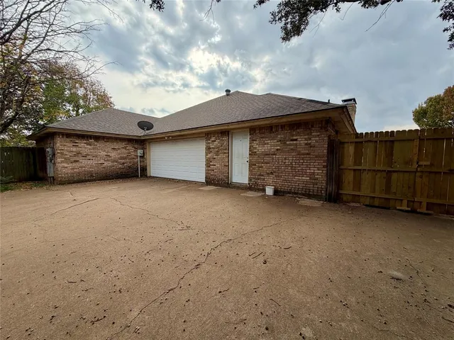 a view of an empty room with wooden fence