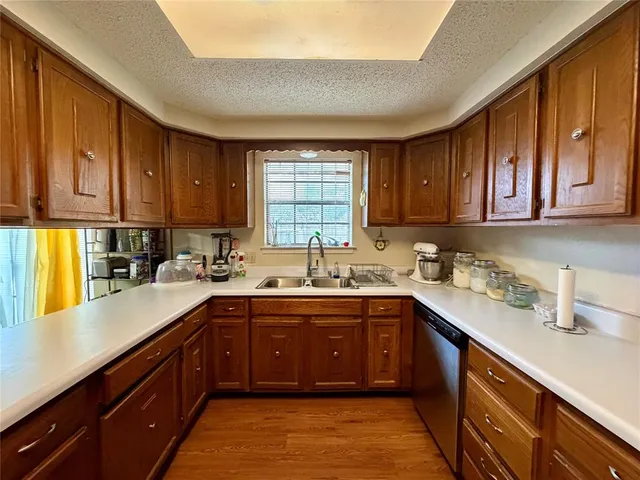a kitchen with a sink a window and cabinets