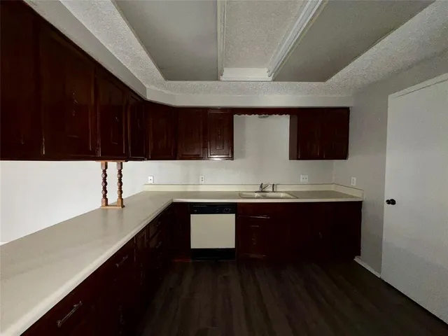 a kitchen with stainless steel appliances a sink dishwasher a stove and a microwave oven