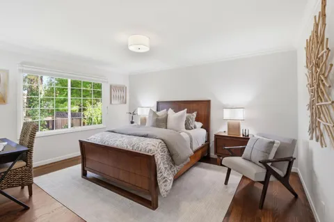 a spacious bedroom with a bed and a window
