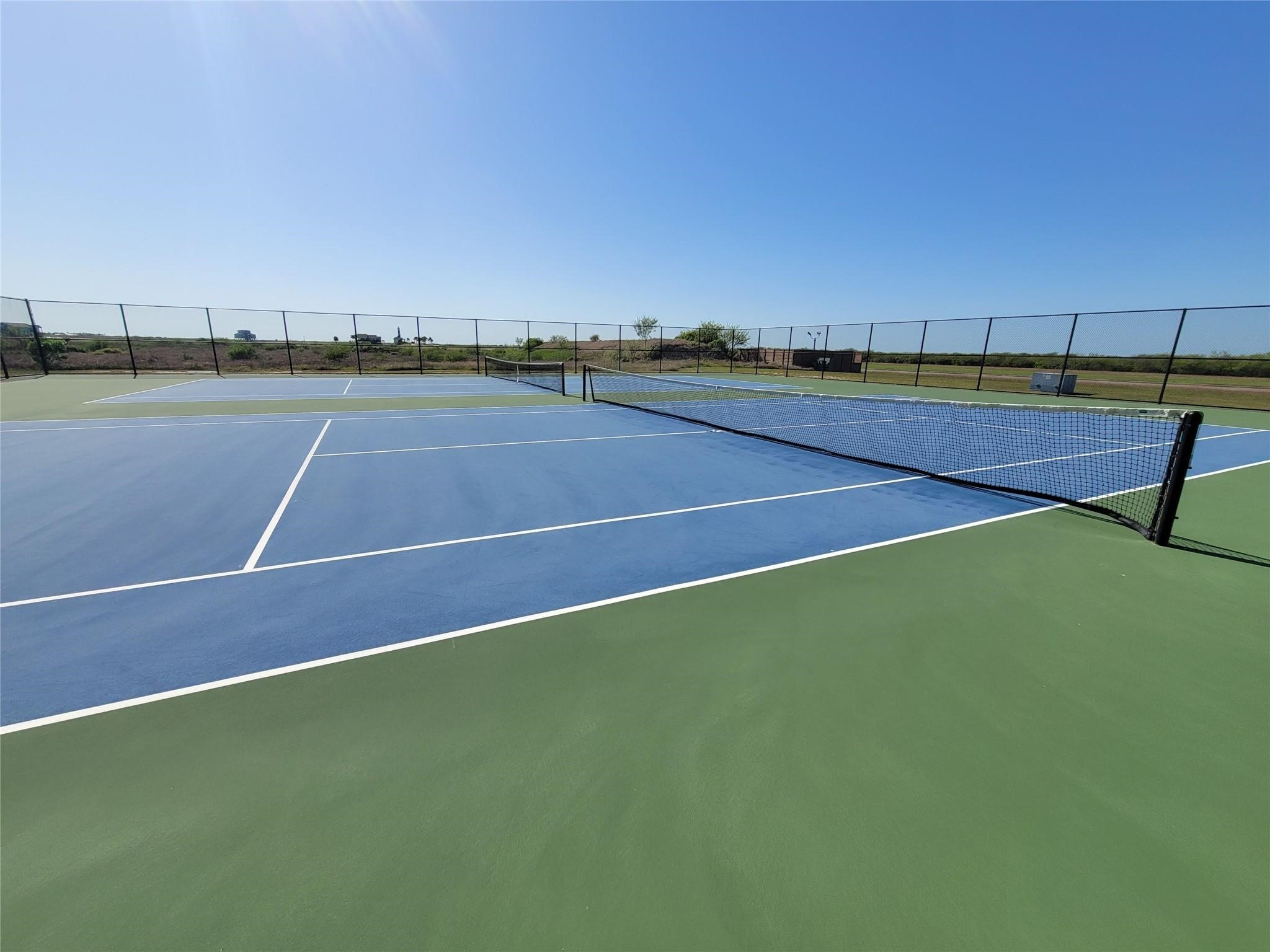 3038 Coastal Spgs Loop Palacios, TX 77465 - Photo 6 of 6 a tennis court that has trees in the background