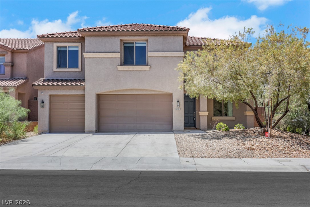 2501 Bechamel Place Henderson, NV 89044 - Photo 2 of 50 A terracotta-tiled roof crowns this stucco-finished residence, featuring an inviting entryway and integrated garages.