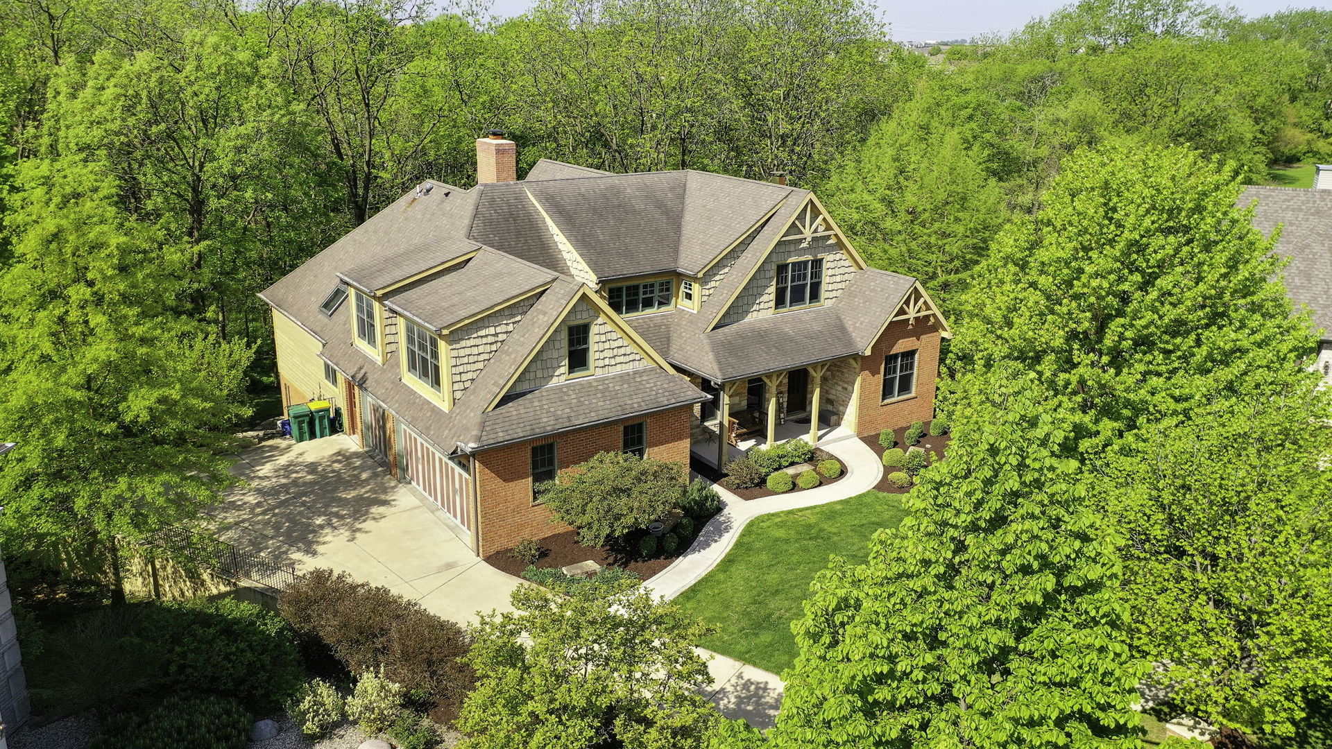 a aerial view of a house with a big yard and large trees