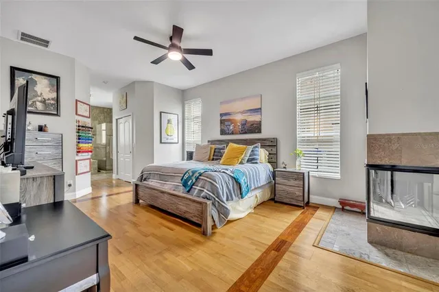 a bedroom with a large bed couch and a window
