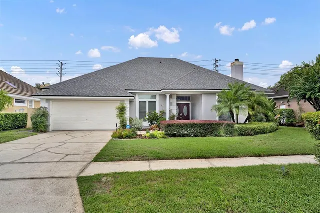 a front view of a house with a garden and plants