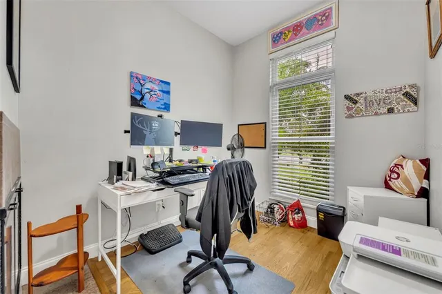 a view of a workspace with furniture and a window