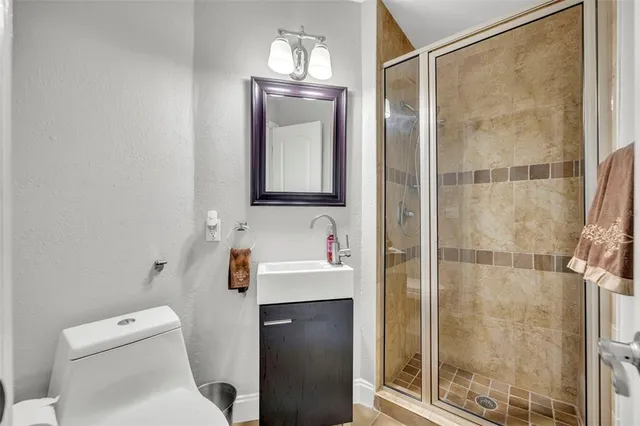 a bathroom with a toilet a sink and shower