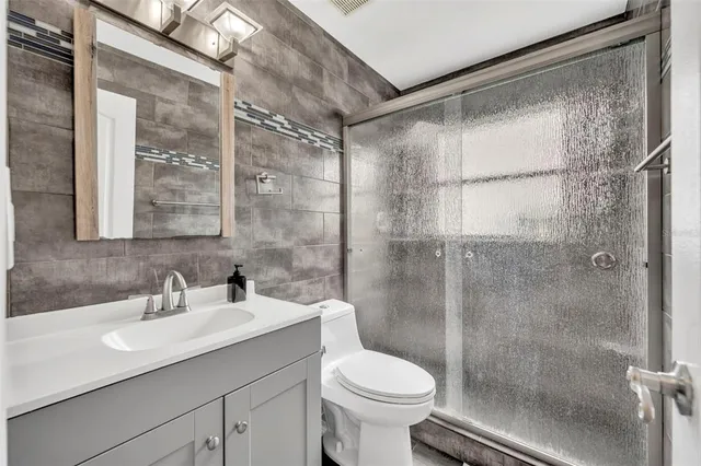 a bathroom with a sink shower and a toilet