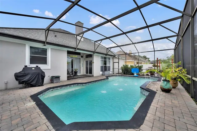 a room with pool table and potted plants
