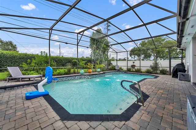 a view of swimming pool with a patio