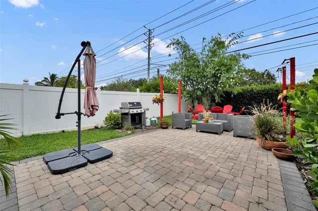 a view of a house with a patio and a garden