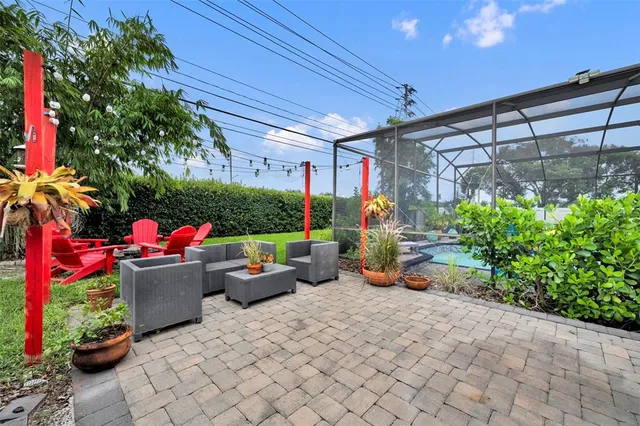 a room with lots of potted plants and a table