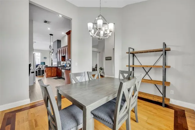 a view of a dining room with furniture and a chandelier