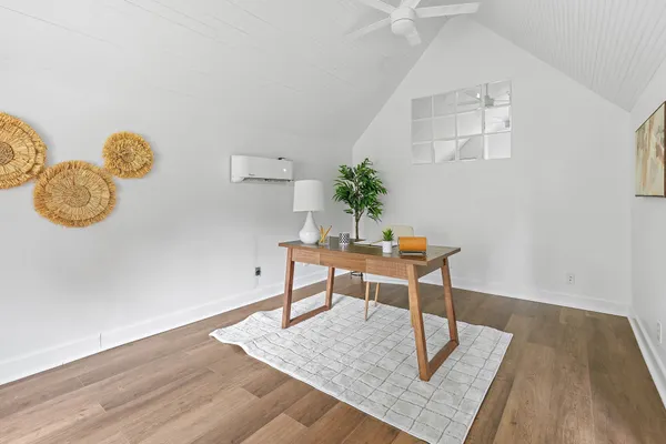 a workspace room with furniture and wooden floor