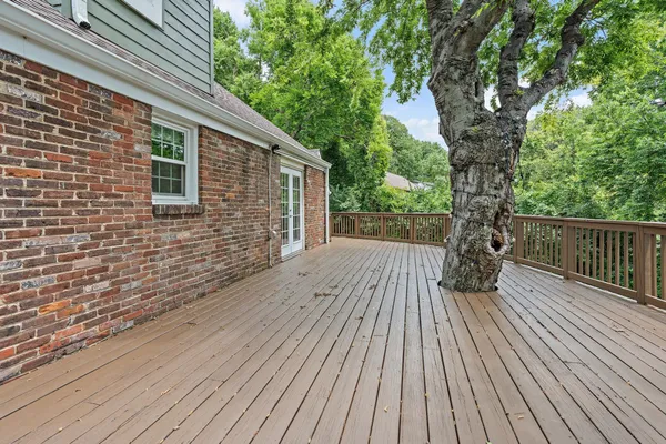 a view of backyard with a deck and wooden floor