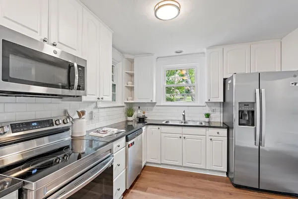 a kitchen with a sink stove and microwave
