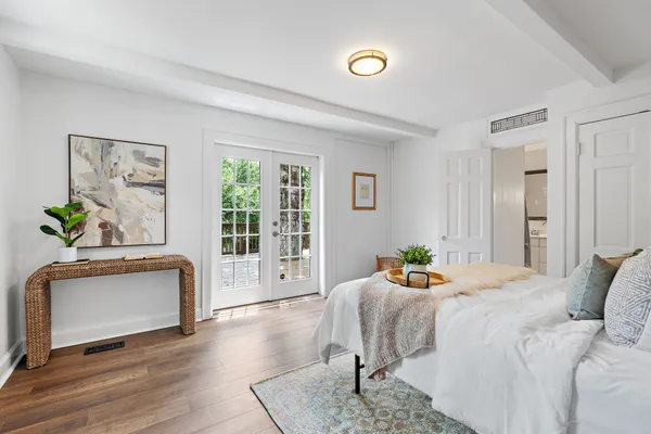 a bedroom with a bed and wooden floor