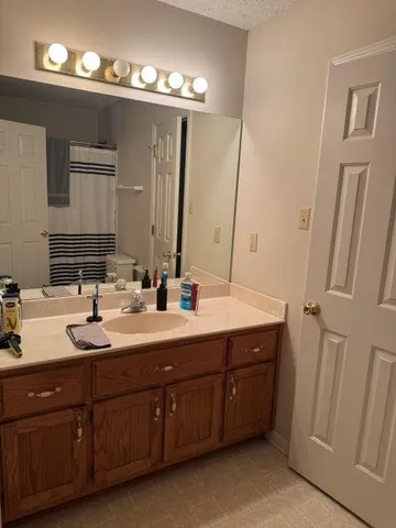 a spacious bathroom with double vanity and a mirror