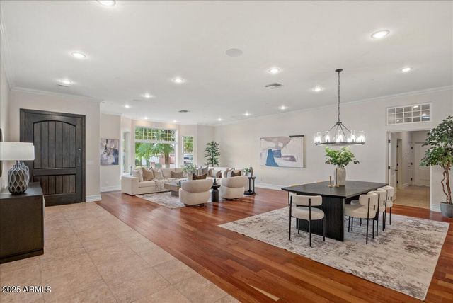 a dining room with furniture and chandelier