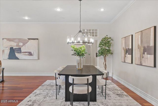 a living room with furniture a fireplace and a chandelier