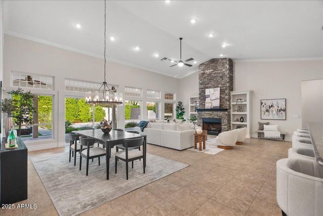 a utility room with granite countertop a sink a stove and cabinets