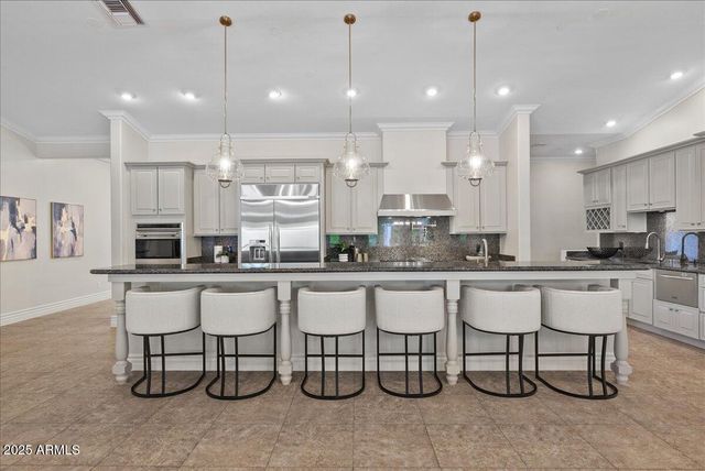 a bathroom with a granite countertop sink a toilet and a bathtub
