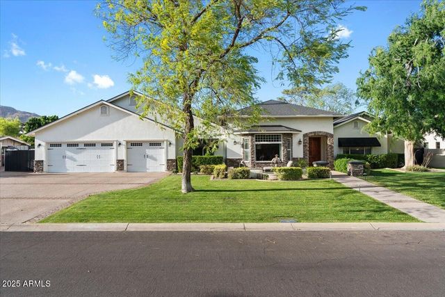 a kitchen with stainless steel appliances kitchen island granite countertop a sink and cabinets