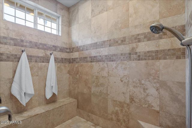 a bathroom with a granite countertop double vanity sink shower and a mirror