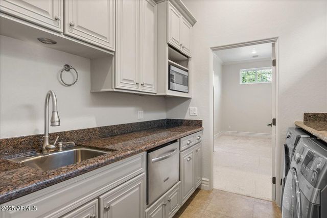 a bathroom with a granite countertop sink a toilet and shower