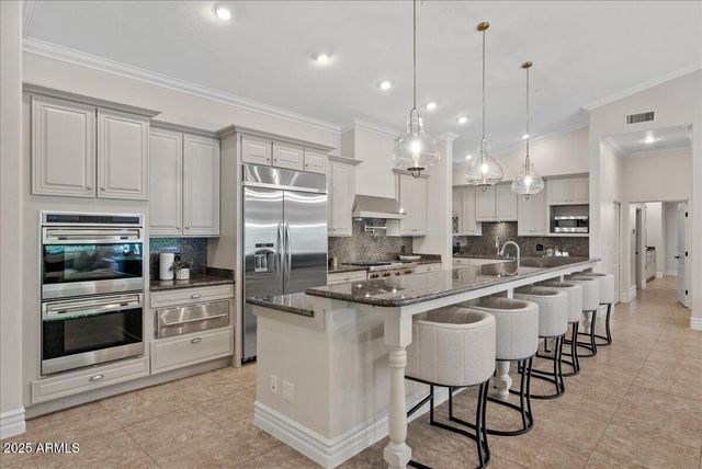 a front view of a house with a yard and trees