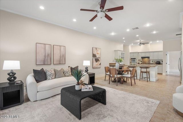 a living room with furniture and a potted plant