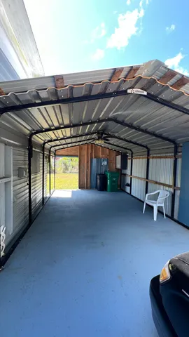 a view of a patio with table and chairs with wooden floor