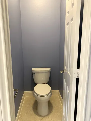 a white toilet sitting next to a small sink