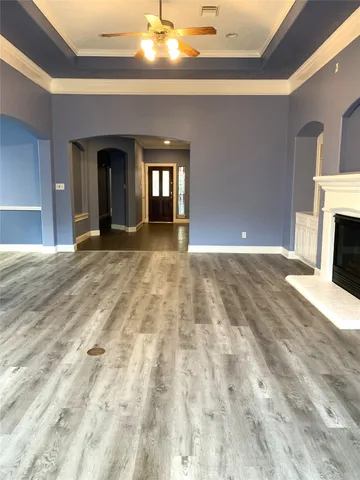 a view of an empty room with window and fireplace