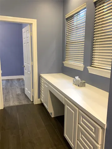 a bathroom with a granite countertop sink and a window