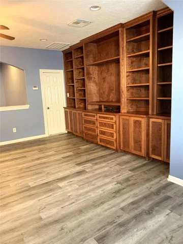 a view of a room with furniture and wooden floor