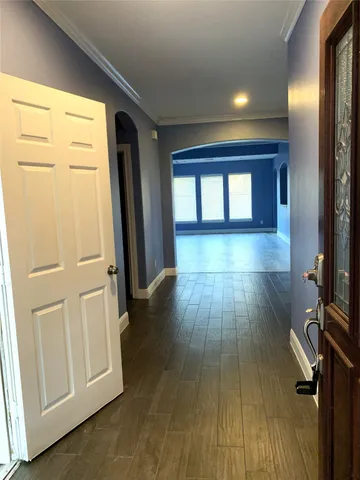 a view of a hallway with wooden floor