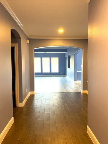 a view of a room with wooden floor and a window