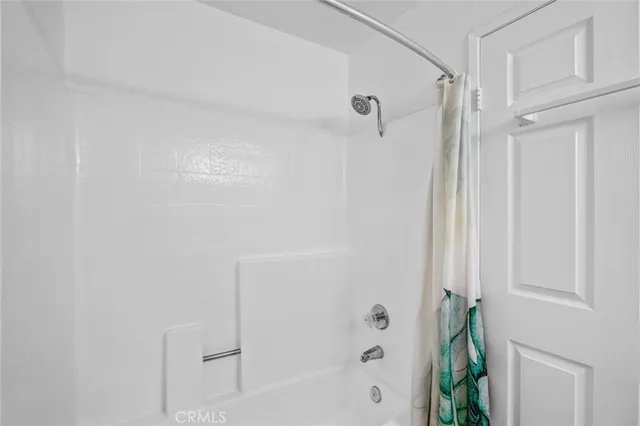 a bathroom with a granite countertop sink a toilet and shower