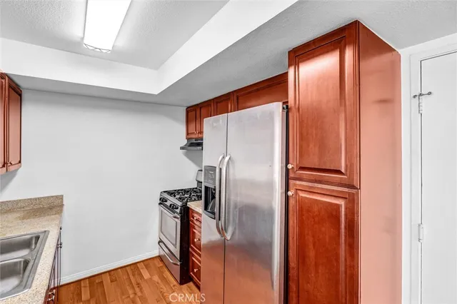 a metallic refrigerator freezer sitting in a room
