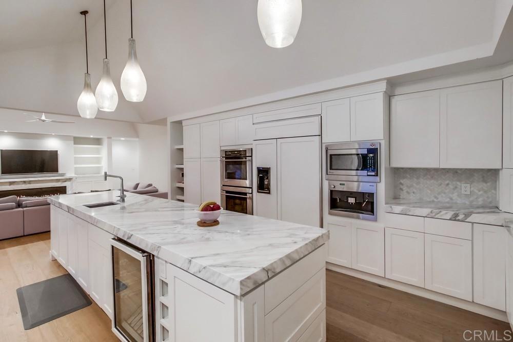 4124 Stonebridge Lane Rancho Santa Fe, CA 92091 - Photo 14 of 31 a kitchen with stainless steel appliances granite countertop a sink dishwasher a stove and a microwave oven with cabinets