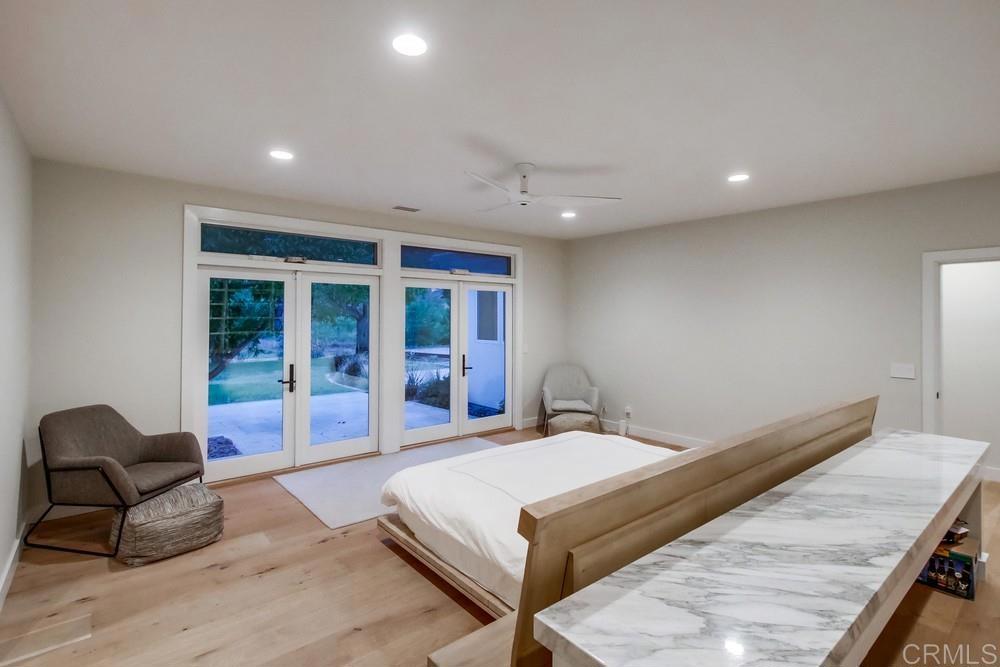 4124 Stonebridge Lane Rancho Santa Fe, CA 92091 - Photo 18 of 31 a living room with a couch and a large window