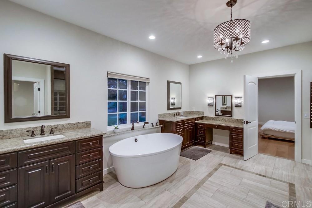 4124 Stonebridge Lane Rancho Santa Fe, CA 92091 - Photo 19 of 31 a bathroom with a sink double vanity granite tub and a mirror