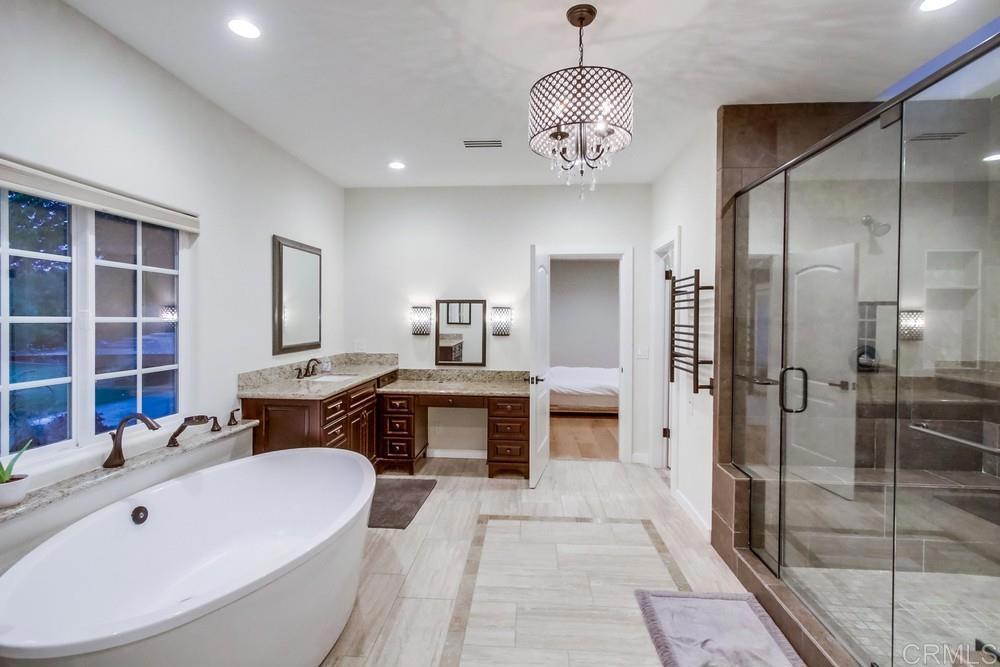 4124 Stonebridge Lane Rancho Santa Fe, CA 92091 - Photo 20 of 31 a spacious bathroom with a tub sink and mirror