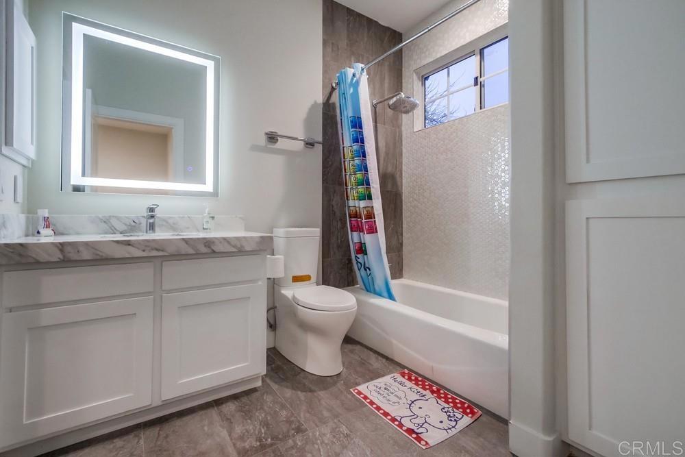 4124 Stonebridge Lane Rancho Santa Fe, CA 92091 - Photo 22 of 31 a bathroom with a granite countertop sink toilet and shower