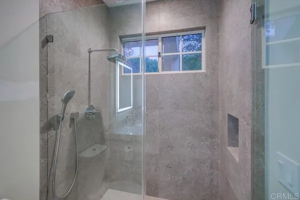 a bathroom with a granite countertop sink a toilet and mirror